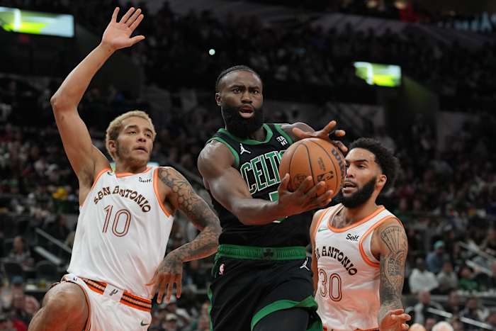 Dec 31, 2023; San Antonio, Texas, USA; Boston Celtics guard Jaylen Brown (7) loses the ball in front of San Antonio Spurs forwards Jeremy Sochan (10) Julian Champagnie (30) in the first half at Frost Bank Center.
